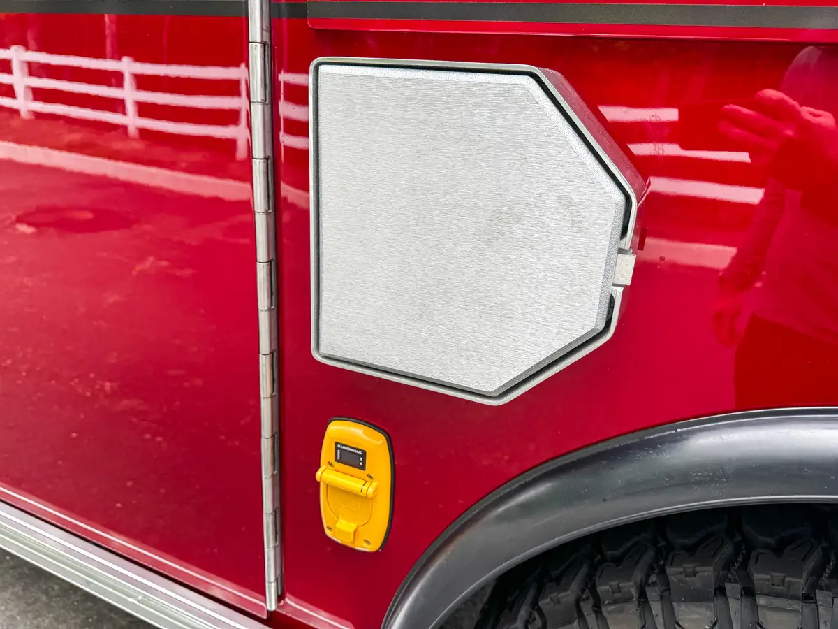 Open side fill-port door detail showing circular intake opening.